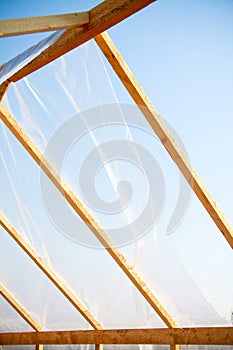 Wooden greenhouse covered with polyethylene