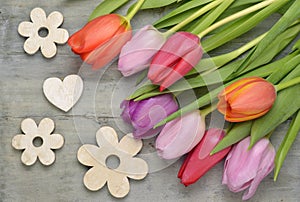 Wooden grey empty copy space Easter background with colorful tulips