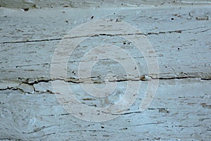 Wooden grey faded logs background with flaws and splits