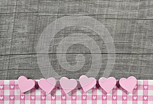 Wooden grey shabby chic background with pink hearts on a white r