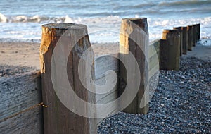 Wooden Groyne on beach to protect beach from longshore drift photo