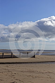 A Wooden Groyne near to a River outlet on the gently shelving sand beach of Monifieth