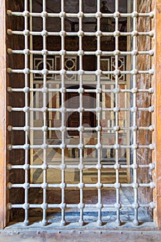 Wooden grunge window with iron grid revealing interior of Mausoleum of Sultan Barquq, Cairo, Egypt