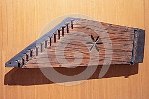 Wooden Gusli on wood background. Ancient East Slavic stringed plucked musical instrument. Top view, close-up