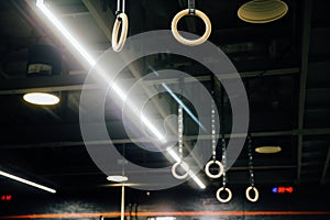 Wooden Gymnastic rings in the interior of the gym loft. Nobody.