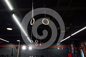 Wooden Gymnastic rings in the interior of the gym loft. Nobody.