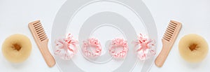 banner with doughnut, wooden Hairbrush, Pink Scrunchy on white. Flat lay Hairdressing tool Hair ties