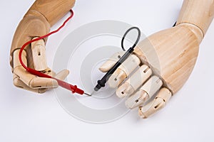 Wooden Hand and electric multimeter