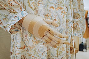 Wooden hand of mannequin in female dress screenings