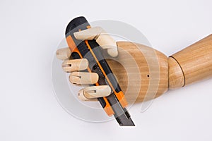 Wooden hand with office cutting knife
