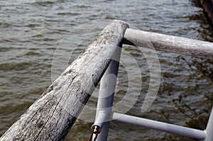 Wooden hand rail along a pier