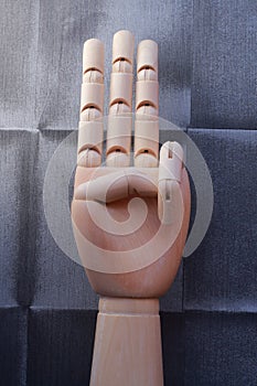 Wooden hand with three raised fingers