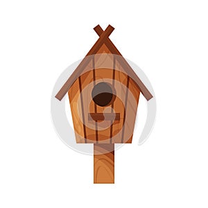 Wooden handmade bird house isolated on white background. Cartoon homemade nesting box with a pole, ecology birdbox for