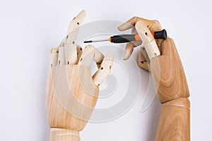 Wooden hands and screwdriver