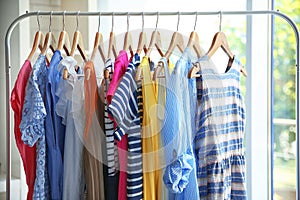 Wooden hangers with different female clothes