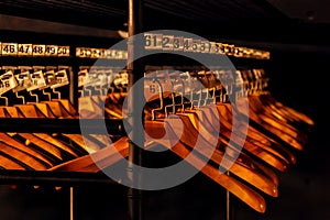 Wooden hangers with numbers in dark cloakroom