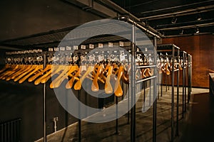 Wooden hangers with numbers in dark empty cloakroom or checkroom or wardrobe photo