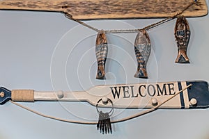 Wooden hangers in the shape of a paddle in the hallway in the marine style