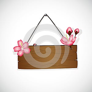 Wooden hanging sign with cherry blooming flowers pink petals