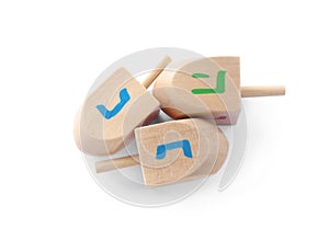 Wooden Hanukkah traditional dreidels on white background, top view