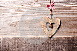Wooden heart with bell decoration on vintage oak background, spa