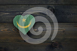 wooden heart with national flag of mauritania on the wooden background