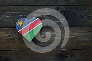 wooden heart with national flag of namibia on the wooden background