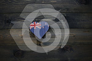 wooden heart with national flag of new zealand near reduce, reuse and recycle sing on the wooden background. concept