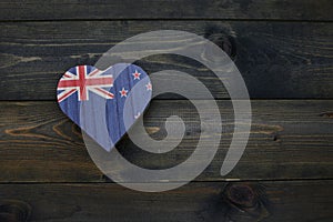 wooden heart with national flag of new zealand on the wooden background
