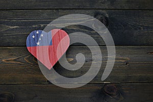 wooden heart with national flag of Samoa on the wooden background
