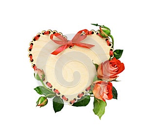 Wooden heart with red ribbon decoration and rose flowers and leaves isolated on white