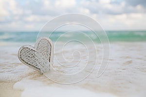 wooden heart in sea waves, live action