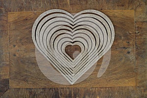 Wooden heart shaped picture frame isolated on wooden background