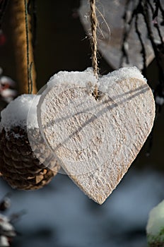 Wooden heart in snow