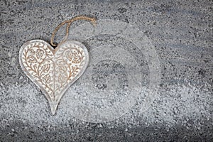 Wooden heart on stone background