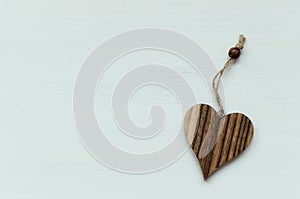 Wooden heart on white background with string