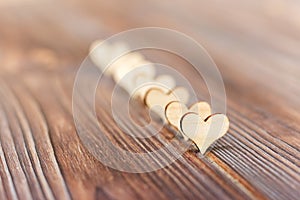 Wooden hearts forming a side border on a rustic wood background Valentines Day