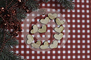 Wooden hearts, New Year tree and decorations on. checkered background. Sp