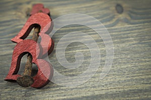 Wooden hearts and rusted nail on rustic background