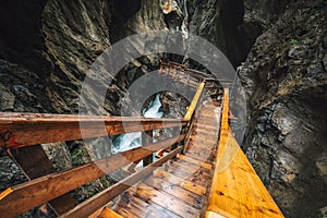 Wooden hike trail path inside a gorge with bue mountain river, Sigmund Thun Klamm, Kaprun, Austria photo