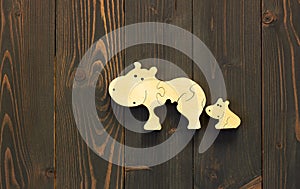 Wooden hippo family toy: mosaic mother and her kid flat on wood