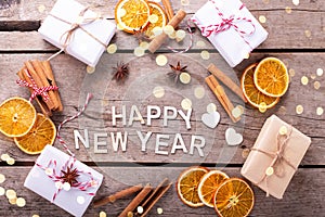 Wooden holliday words,  cinnamone, slices of dried orange, anise on vintage wooden  background. photo