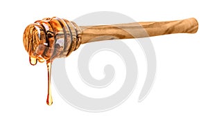 Wooden honey dipper with honey drop on white background