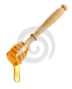 Wooden honey dipper with honey drop on white background