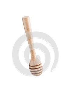 Wooden honey dipper isolated on white backgroiund.