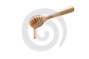 Wooden honey dipper isolated on white backgroiund.