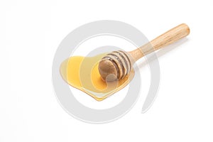 Wooden honey dipper isolated on white backgroiund.