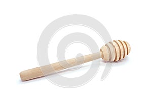 Wooden honey spoon isolated on white background. Clean Honey Honey dipper. One. Close-up.