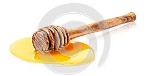 Wooden honey stick with honey drop on white background