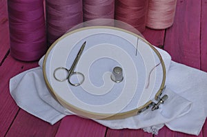 Wooden hoop with the fabric for sewing and embroidery